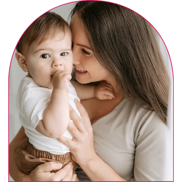 Happy mother holding young child and smiling